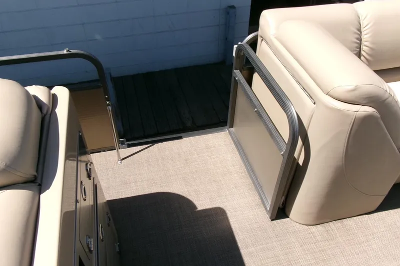 Slide: The Image of Interior of 2015 Manitou 25 SES Flip pontoon boat with beige seating. - 24