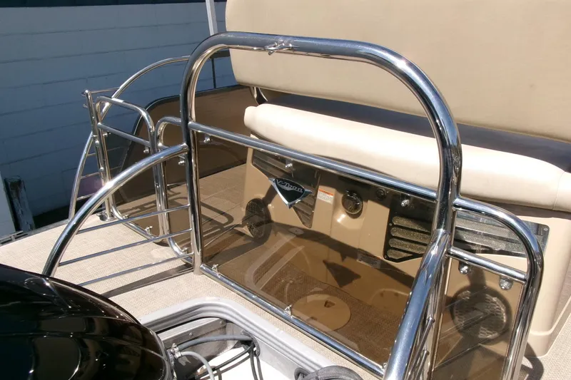 Slide: The Image of 2015 Manitou 25 SES Flip pontoon boat with chrome railing and beige seating. - 27