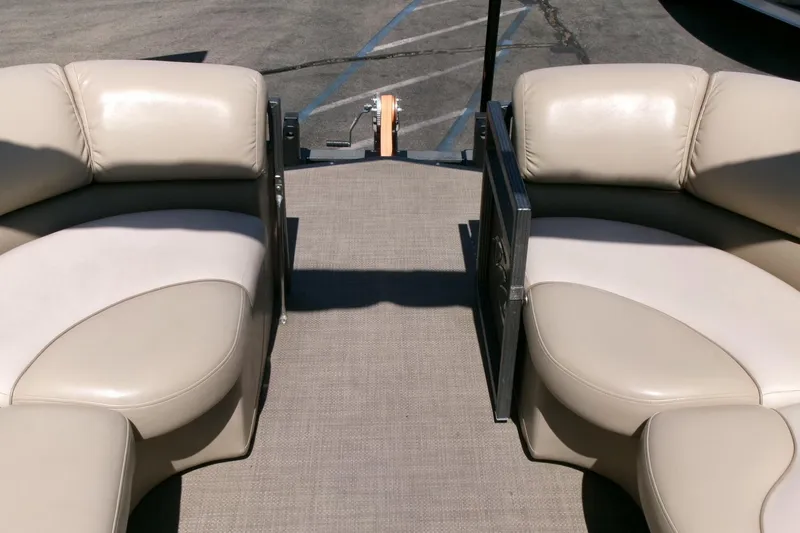 Slide: The Image of 2015 Manitou 25 SES Flip boat interior with beige seating and carpeted floor. - 4