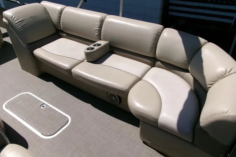 Slide: The Image of Luxurious seating on 2015 Manitou 25 SES Flip pontoon boat with cup holders. - 8