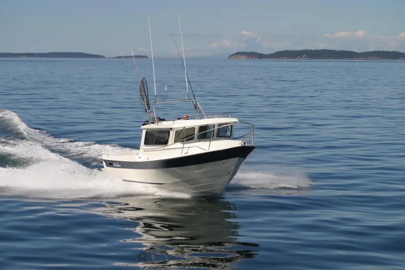 Slide: The Image of 2026 Sea Sport XL 2400 boat cruising on calm ocean waters. - 10