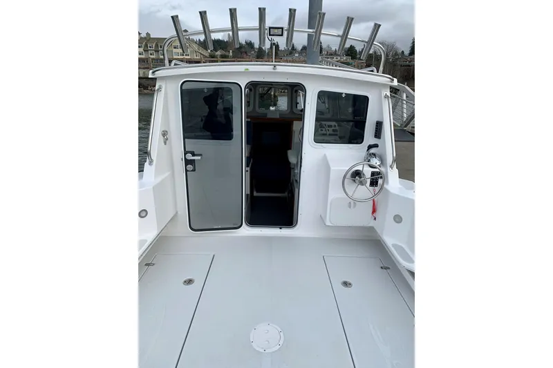 Slide: The Image of 2026 Sea Sport XL 2400 boat with open cabin doors and steering wheel. - 5