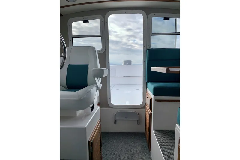 Slide: The Image of Interior view of 2026 Sea Sport XL 2400 boat, featuring seating and helm. - 7