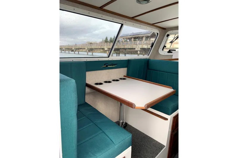 Slide: The Image of Interior of 2026 Sea Sport XL 2400 boat with teal seating and table. - 9