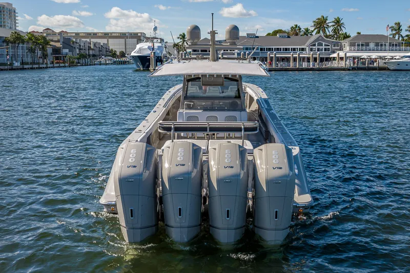 Slide: The Image of 2024 HCB 53 Suenos boat with four powerful outboard engines on the water. - 13