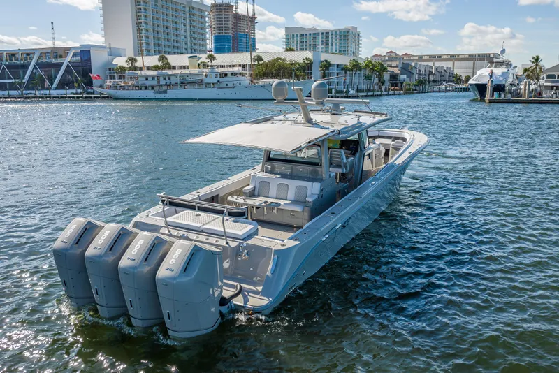 Slide: The Image of 2024 HCB 53 Suenos luxury boat with four powerful engines cruising in a marina. - 14
