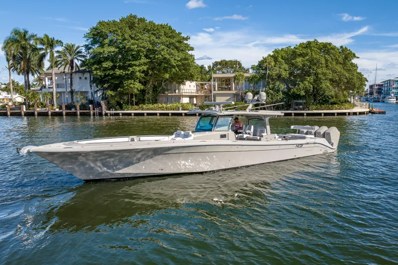 Slide: The Image of 2024 HCB 53 Suenos boat cruising on a scenic waterway with lush greenery. - 15