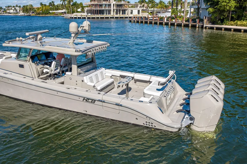 Slide: The Image of 2024 HCB 53 Suenos luxury boat cruising on a sunny waterfront. - 17