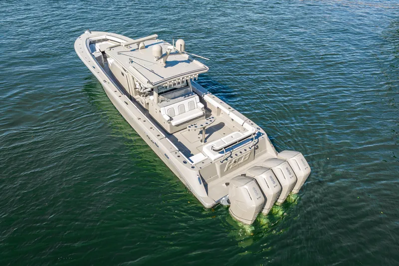 Slide: The Image of 2024 HCB 53 Suenos luxury boat with multiple engines on calm water. - 19