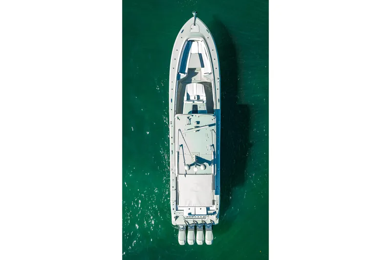 Slide: The Image of Aerial view of 2024 HCB 53 Suenos boat on clear green water. - 2