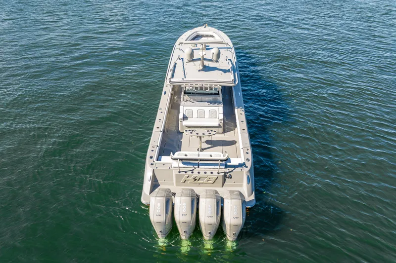 Slide: The Image of 2024 HCB 53 Suenos boat with four powerful engines on open water. - 20
