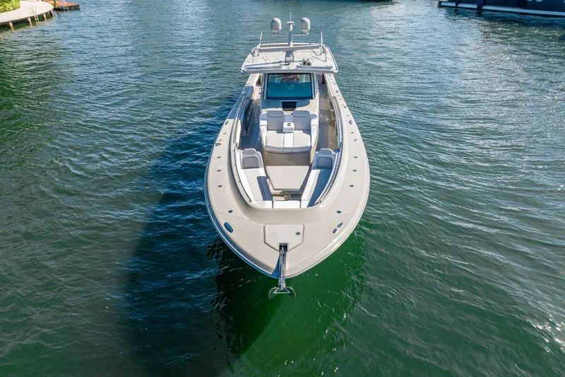 Slide: The Image of 2024 HCB 53 Suenos luxury boat on calm water, showcasing sleek design and spacious deck. - 23