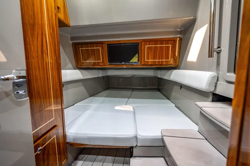 Slide: The Image of Luxurious cabin interior of 2024 HCB 53 Suenos with wood accents and plush seating. - 25
