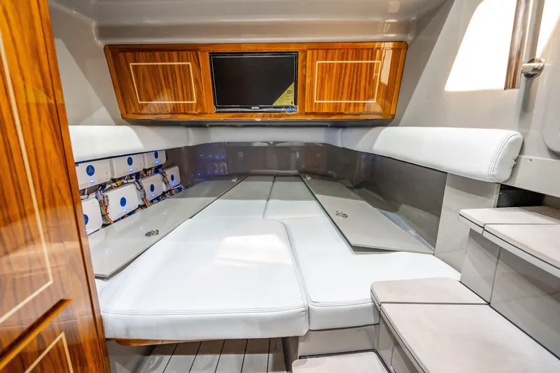 Slide: The Image of Luxurious interior of 2024 HCB 53 Suenos boat with wood accents and white seating. - 29