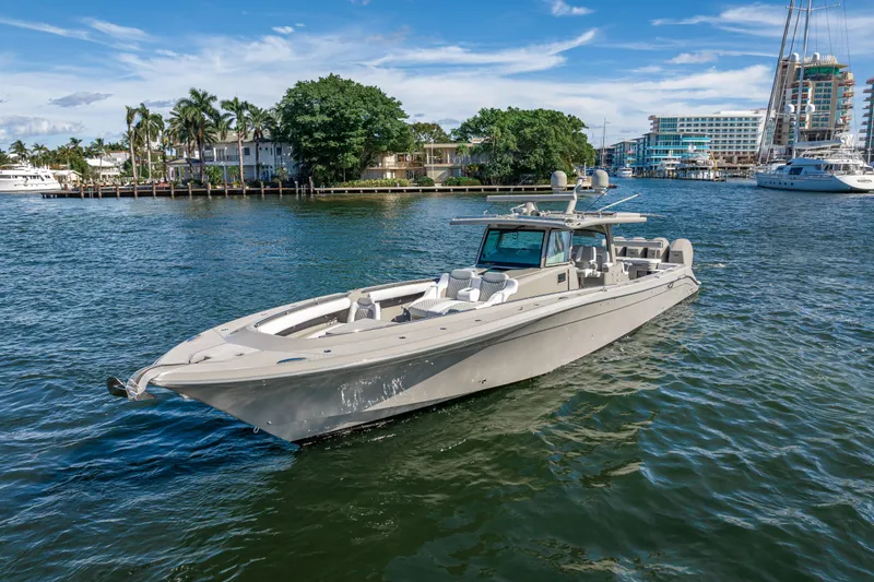 Slide: The Image of 2024 HCB 53 Suenos luxury boat cruising on a scenic waterfront. - 3