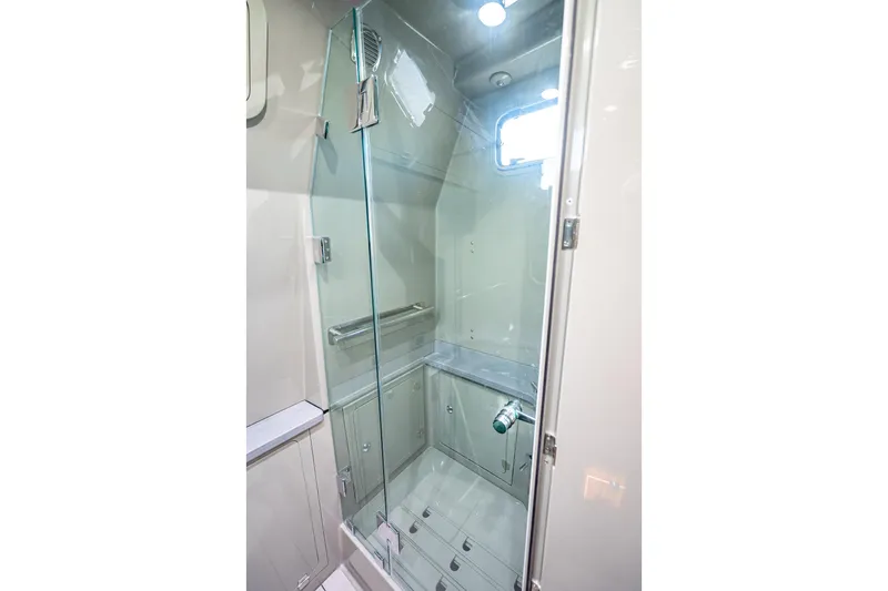 Slide: The Image of Luxurious shower area in 2024 HCB 53 Suenos boat, featuring sleek glass doors. - 32