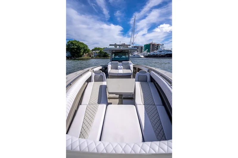 Slide: The Image of 2024 HCB 53 Suenos luxury boat interior with plush seating, docked in a scenic marina. - 39