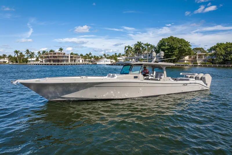 Slide: The Image of 2024 HCB 53 Suenos boat cruising on a sunny day, surrounded by waterfront homes. - 4