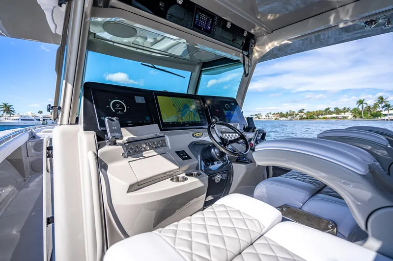 Slide: The Image of 2024 HCB 53 Suenos boat cockpit with advanced navigation system and luxurious seating. - 49