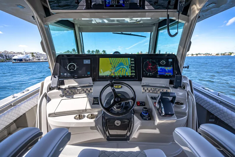 Slide: The Image of Helm of 2024 HCB 53 Suenos boat with advanced navigation displays and controls. - 50