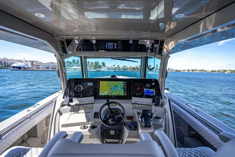 Slide: The Image of 2024 HCB 53 Suenos boat cockpit with advanced navigation systems on open water. - 52