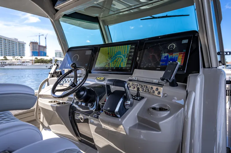 Slide: The Image of 2024 HCB 53 Suenos boat helm with advanced navigation displays and controls. - 53