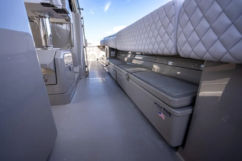 Slide: The Image of 2024 HCB 53 Suenos boat interior with quilted seating and storage compartments. - 56