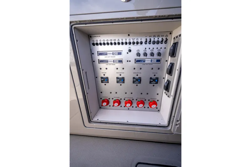 Slide: The Image of Electrical control panel on 2024 HCB 53 Suenos boat, featuring switches and dials. - 58