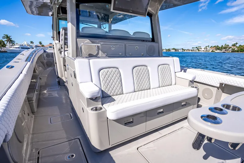 Slide: The Image of 2024 HCB 53 Suenos luxury boat interior with plush seating and ocean view. - 68