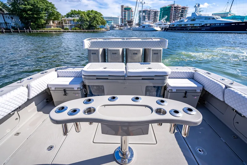 Slide: The Image of 2024 HCB 53 Suenos luxury boat interior with seating and cup holders on water. - 69