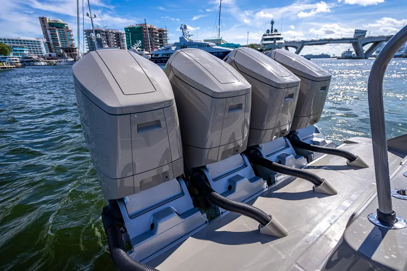 Slide: The Image of Four powerful outboard engines on a 2024 HCB 53 Suenos boat, docked in a marina. - 72