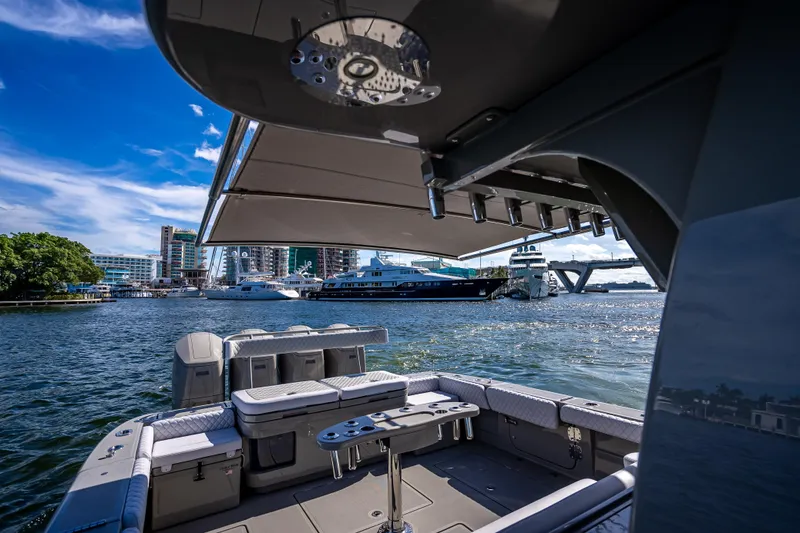 Slide: The Image of 2024 HCB 53 Suenos luxury boat with spacious deck, docked in a scenic marina. - 74