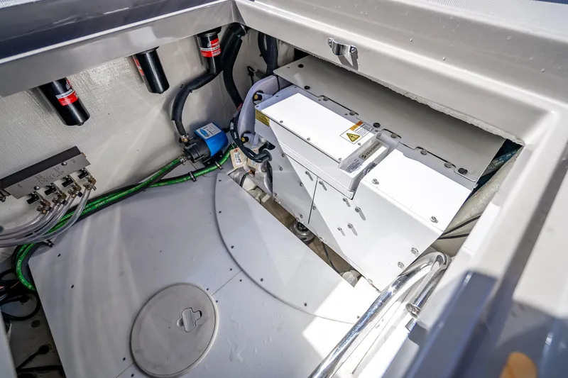 Slide: The Image of Engine compartment of 2024 HCB 53 Suenos boat, showcasing mechanical components and wiring. - 82