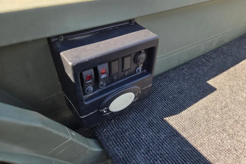 Slide: The Image of Control panel on a 2023 SeaArk 1648 MV boat, featuring switches and outlets. - 6