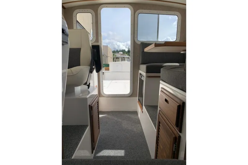 Slide: The Image of Interior view of 2026 Sea Sport Kenai 2600 boat, featuring seating and storage. - 12