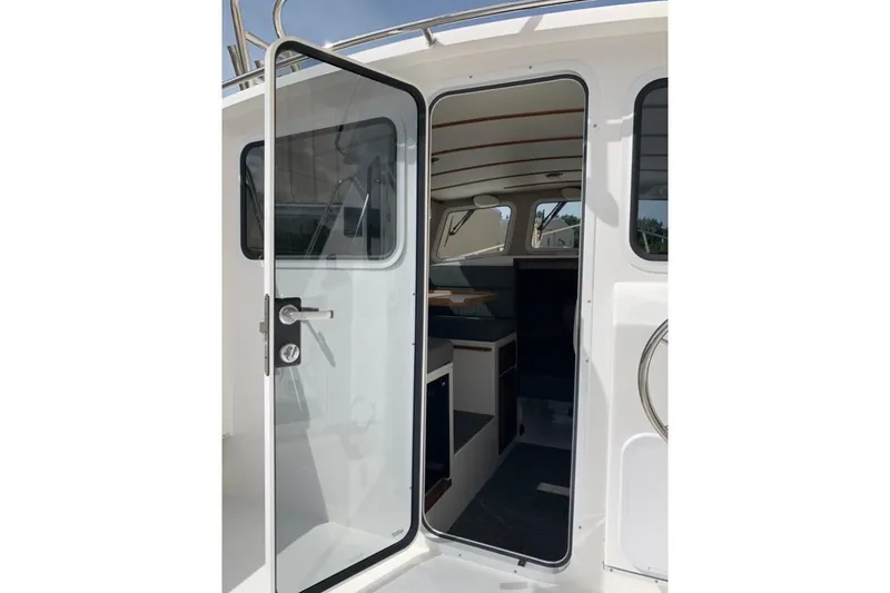 Slide: The Image of 2026 Sea Sport Kenai 2600 boat interior view through open door. - 4