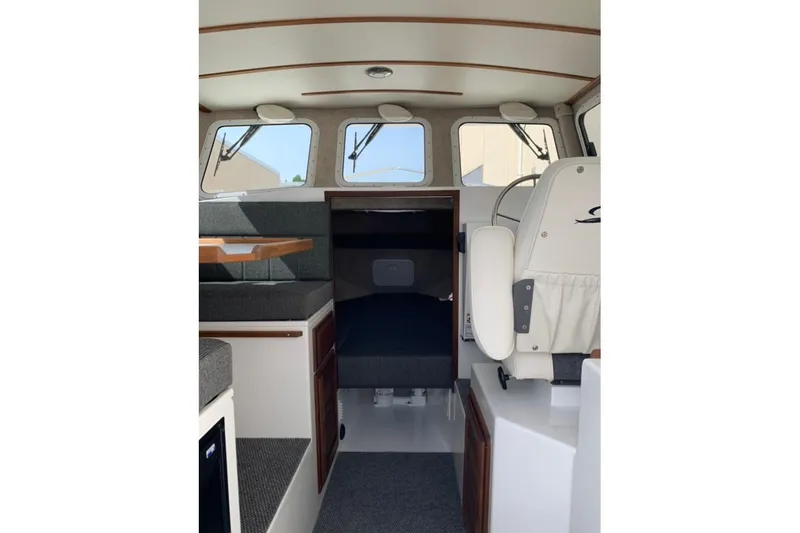 Slide: The Image of Interior of 2026 Sea Sport Kenai 2600 boat, featuring seating and helm area. - 5