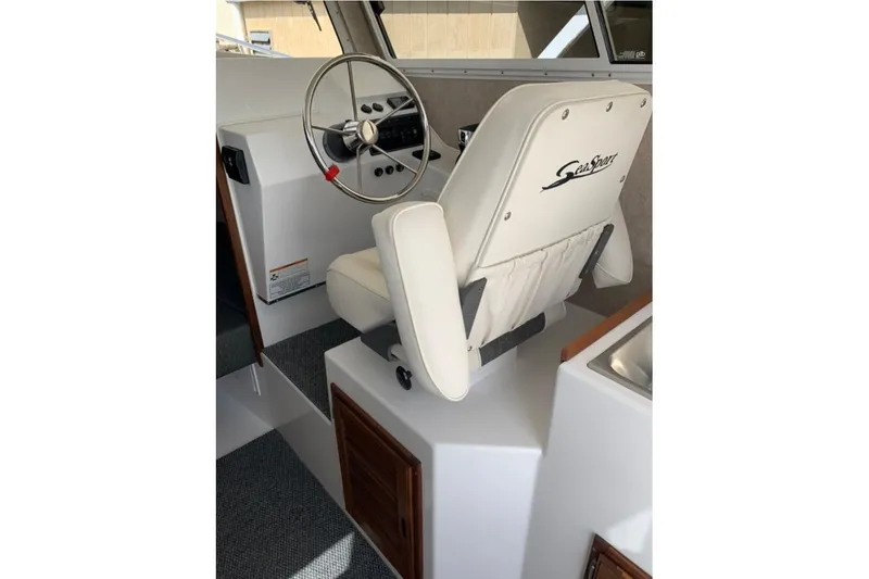 Slide: The Image of Interior of 2026 Sea Sport Kenai 2600 boat with steering wheel and captain's chair. - 6