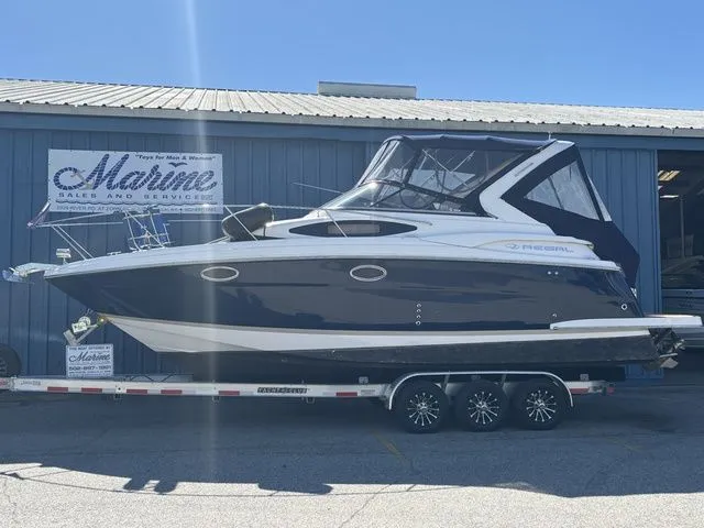 The Image of 2014 Regal Express Cruiser 30 on trailer outside marine building. - 1