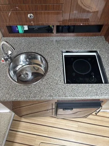 Slide: The Image of Galley in 2014 Regal Express Cruiser 30 with sink and cooktop. - 31