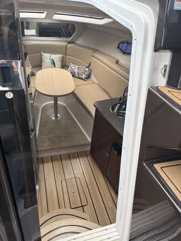 Slide: The Image of Interior of a 2014 Regal Express Cruiser 30 with seating area and table. - 34