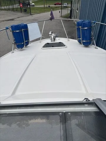 Slide: The Image of 2014 Regal Express Cruiser 30 boat, front deck view with blue fenders. - 36