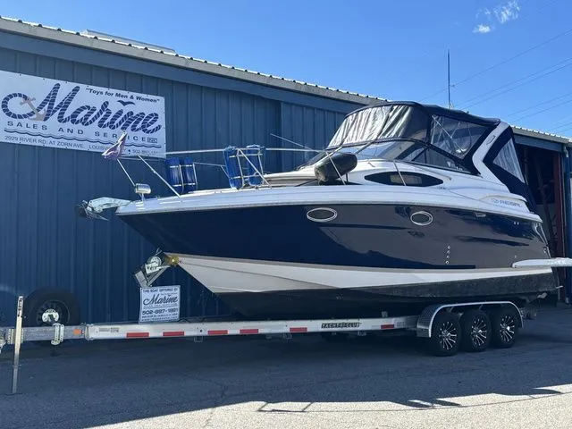 Slide: The Image of 2014 Regal Express Cruiser 30 on trailer outside marine shop. - 4