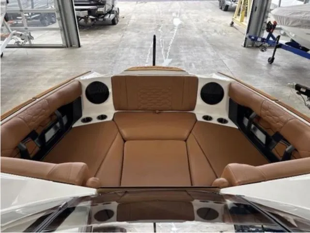 Slide: The Image of 2026 Malibu Wakesetter 24 MXZ interior with brown leather seating. - 11