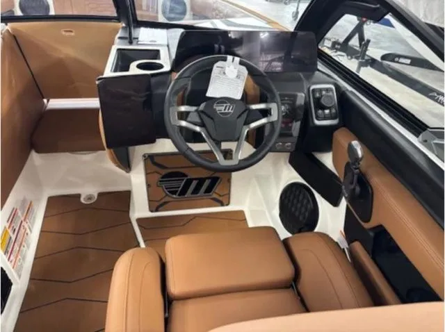 Slide: The Image of 2026 Malibu Wakesetter 24 MXZ interior with brown leather seats. - 13