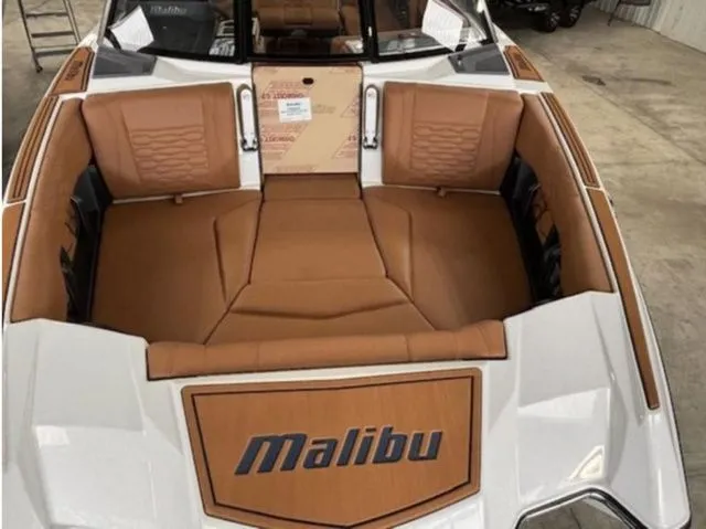 Slide: The Image of Interior of 2026 Malibu Wakesetter 24 MXZ with brown leather seating. - 16