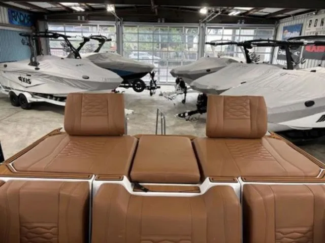 Slide: The Image of 2026 Malibu Wakesetter 24 MXZ in a boat workshop. - 9