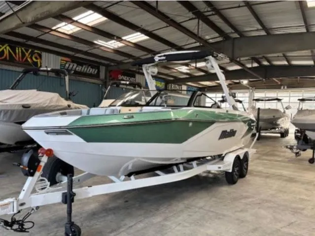 Slide: The Image of 2026 Malibu Wakesetter 23 LSV boat in a warehouse. - 2