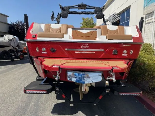 Slide: The Image of Red 2026 Malibu Wakesetter 25 LSV boat, rear view on parking lot. - 5