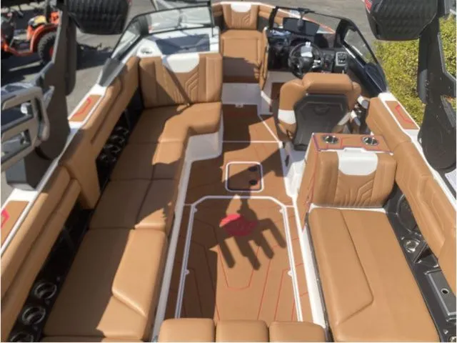Slide: The Image of Interior of 2026 Malibu Wakesetter 25 LSV with brown leather seating. - 7